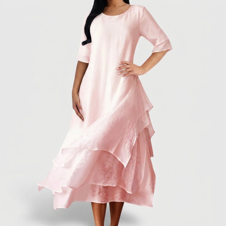 Women's blush pink layered midi dress with asymmetrical hem and three quarter sleeves