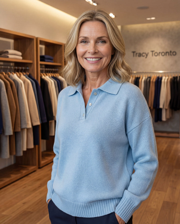 Womens collared knit pullover sweater with long sleeves, button placket and relaxed silhouette displayed in a modern clothing boutique