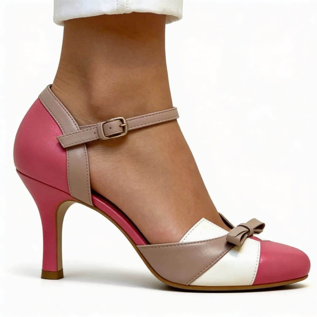 Womens bow accent Mary Jane pumps featuring a rounded toe, ankle strap fastening, contrast colour block panels and slim high heel
