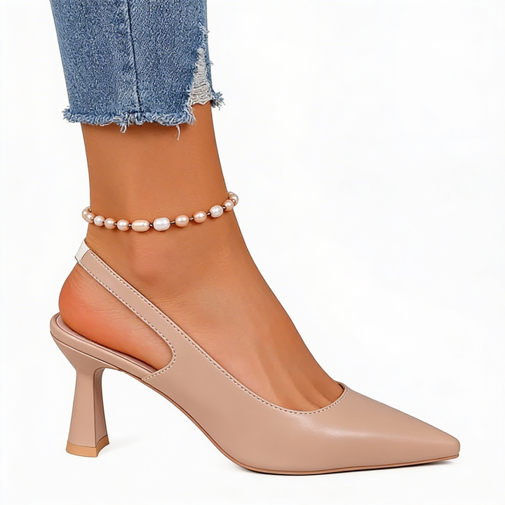 Womens pointed toe slingback flared heels featuring a sleek pointed toe, open back silhouette and sculpted mid heel design