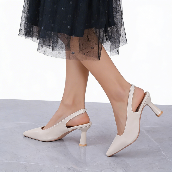 Womens pointed toe slingback midi pumps featuring a sleek pointed toe silhouette, open back design and sculpted mid heel