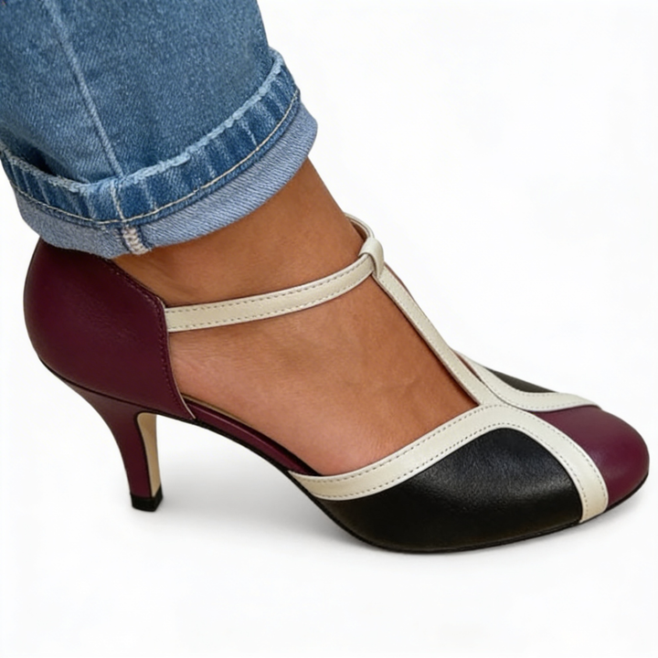 Womens retro colour block T strap heels featuring contrast panel detailing, rounded toe design and slim mid height heel