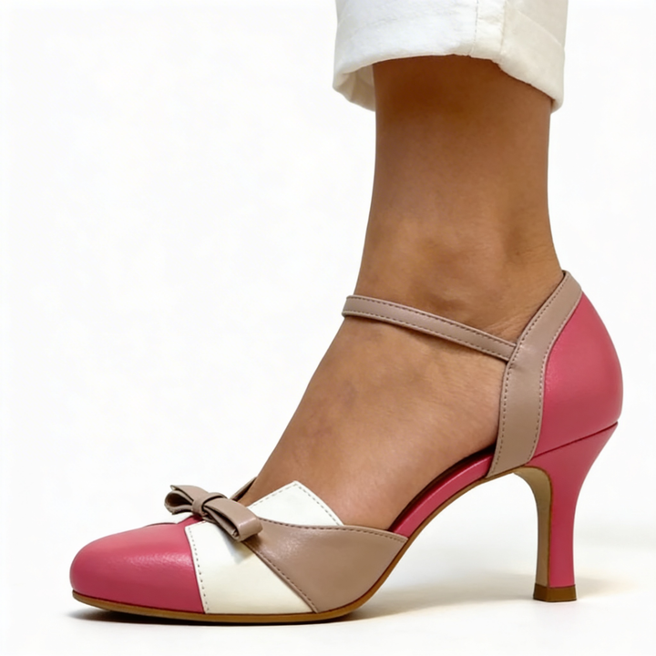 Womens vintage bow detail ankle strap heels featuring a rounded toe, contrast colour block panels, decorative bow accent and slim heel design