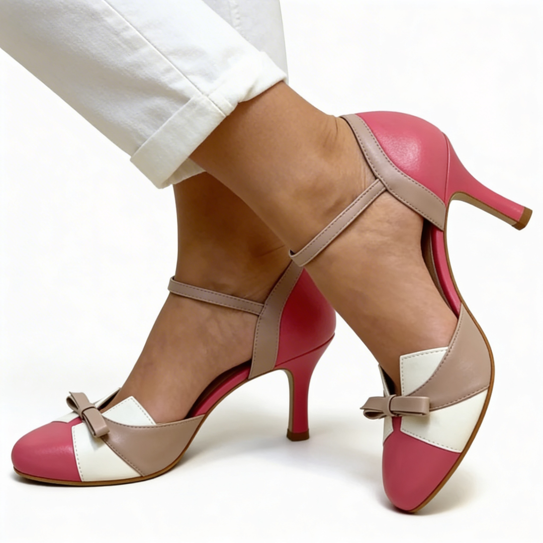 Womens vintage bow detail colour block heels featuring a rounded toe, contrast panel design, decorative bow accent and mid height heel