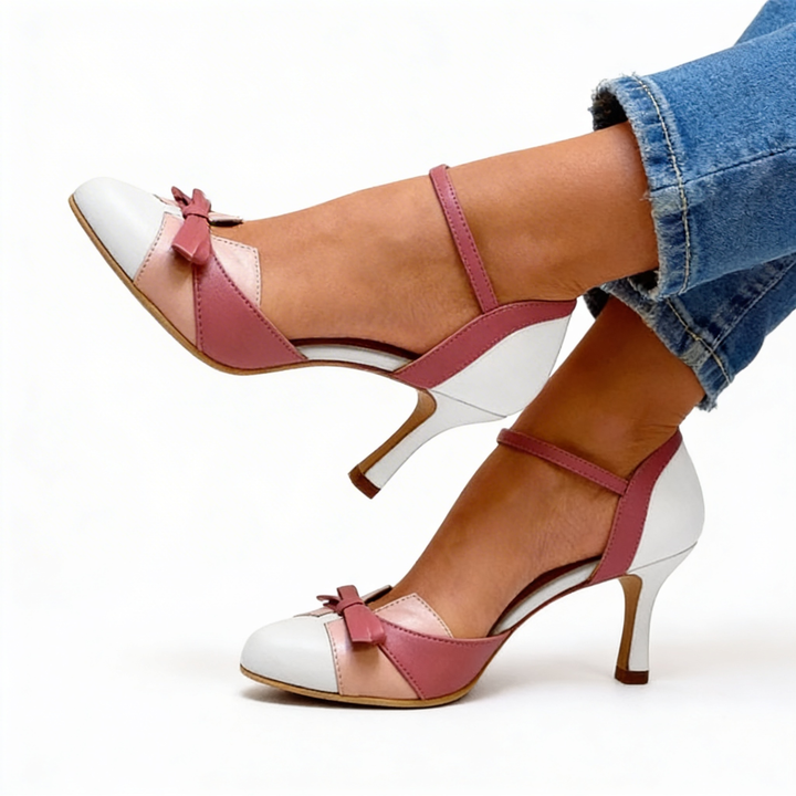 Womens vintage bow detail colour block pumps featuring a rounded toe, decorative bow accent, contrast panel design and slim heel silhouette